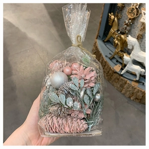 Pink and silver DIY Christmas pinecone kit in clear bag with decorative glitter greenery