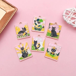 Macro shot of six tarot cat enamel charms including The Lovers and The Empress designs