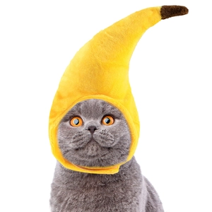 Close-up of bright yellow plush banana headwear for cats with soft fabric texture