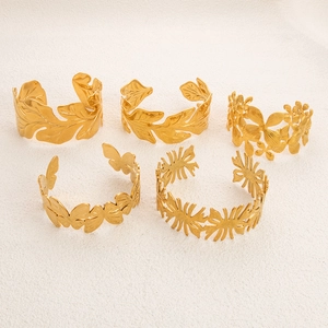 Detailed set of 5 18k gold plated stainless steel cuff bracelets with leaf and floral motifs
