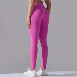 Detail of seamless scrunch butt yoga leggings in vibrant pink with cross waist design