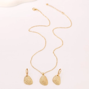 Irregular textured gold necklace and earrings set with hammered water drop pendants