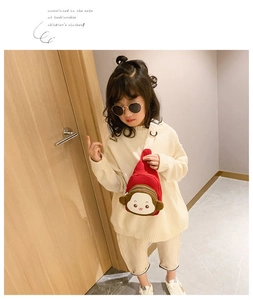 Asian girl wearing a red cartoon monkey crossbody chest bag with adjustable strap