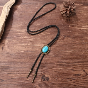 Classic western bolo tie with blue turquoise stone on vintage bronze base and black cord
