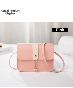 Detail of pink faux leather mini crossbody bag with pearl charms and gold metal ring