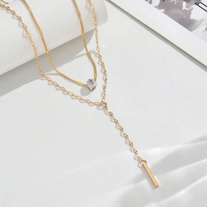 Double-layer gold Y-necklace featuring a water drop crystal and geometric vertical bar