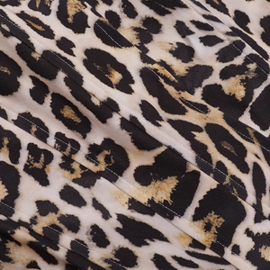 Close-up of high-quality leopard print fabric with detailed textile texture and stitching
