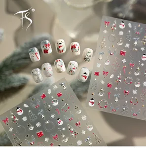 Macro view of luxury 3D embossed Christmas nail stickers with gold bells and tree designs