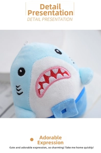 Close-up of shark plush keychain showing detailed embroidery and soft blue fabric texture