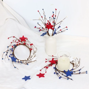 Detail of 4th of July candle ring with red white blue berries and patriotic stars