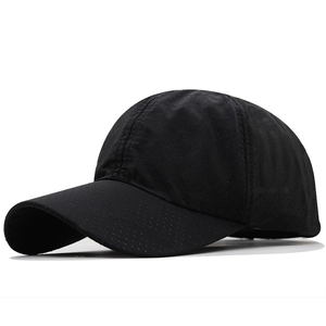 Close-up of black breathable baseball cap with laser-cut ventilation holes and quick-dry fabric