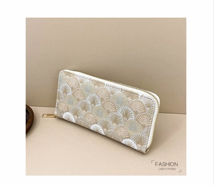 Close-up of elegant long zipper wallet with champagne shell pattern embroidery detail