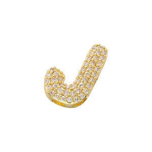 Macro shot of hip hop style gold plated letter J pendant with micro pavé cubic zirconia