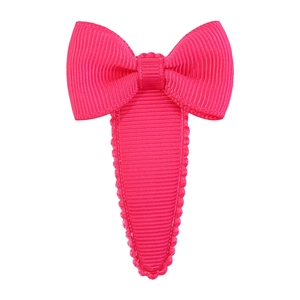 Detailed view of a hot pink grosgrain ribbon bow hair clip with textured fabric finish