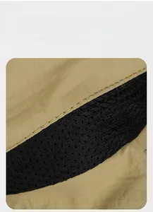 Detail of khaki outdoor hat showing breathable black honeycomb mesh and fine stitching