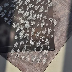 3D embossed nail art stickers with white floral and bow designs for manicure art