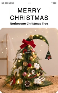 Detail of DIY mini Christmas tree with red bows, pine cones and warm LED lights decor