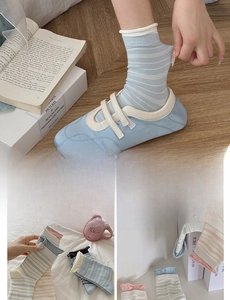 Detail of striped cotton socks with ruffled cuffs shown in multiple pastel colors