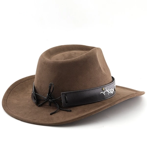 Detail of a brown suede cowboy hat featuring a black leather band with silver embroidery