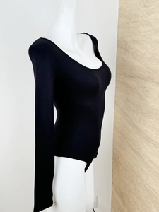 Detail view of black ribbed knit bodysuit with slim fit design and U-neck silhouette