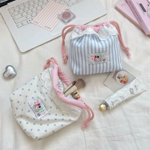 Détail de pochettes à cordon en dentelle avec rayures bleues et motifs d'étoiles