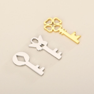 Close-up of heart-shaped hollow key pendants in gold and silver stainless steel