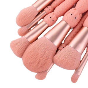 Pink mermaid makeup brush set with rose gold ferrules and soft bristles on white background