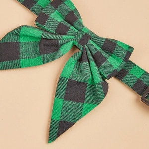 Close-up of green and black plaid bowtie accessory with a durable black buckle clasp