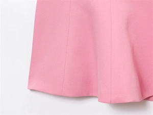 Detail of pink tube top hem showing fine woven texture and premium double stitching