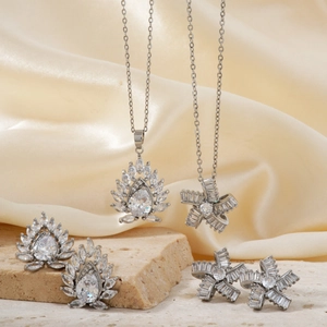 Elegant silver jewelry set with lotus and bow designs featuring zircon stones and gems