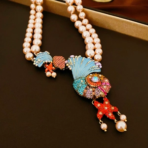 Macro shot of double-layer pearl necklace with colorful rhinestone nautilus and starfish