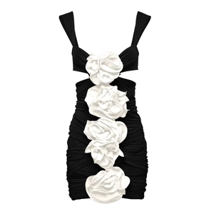 Detail of ruched black one-piece swimsuit with large 3D white floral decorations