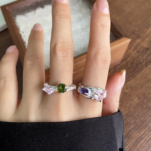 Detail of 925 silver rings with heart shaped pink gems and irregular lava texture