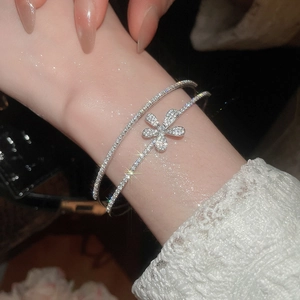 Close-up of elegant zircon flower double-layered silver bracelet worn on wrist
