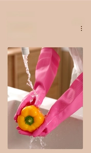 Detail of rose pink rubber cleaning gloves with non-slip texture for kitchen washing