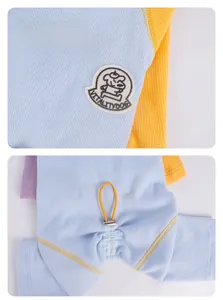 Detail of dog shirt with blue ribbed fabric, yellow cuffs, and adjustable drawstring hem
