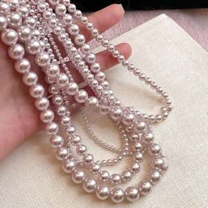 Detailed view of elegant lavender and pink pearl necklaces in various sizes and luster
