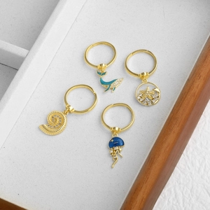 Set of four 18k gold plated adjustable ocean theme rings with blue enamel sea creature charms