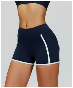 Close-up of high-waist navy yoga shorts with white contrast binding for fitness training