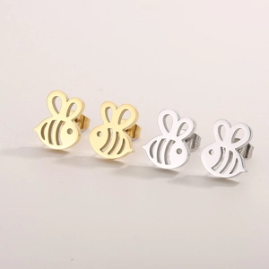 Detailed close-up of bee-shaped stud earrings in gold and silver stainless steel finishes