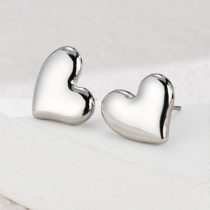 Minimalist silver heart stud earrings in polished stainless steel with metallic shine