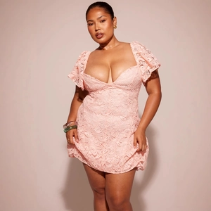 Elegant pink lace V-neck dress with puff sleeves and cinched waist for a romantic look