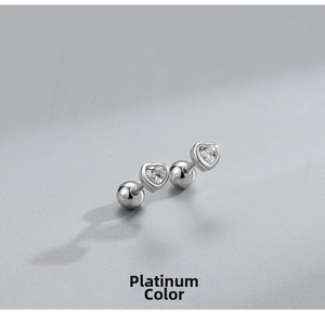 Macro detail of S925 sterling silver heart studs with white gold finish and screw backings