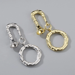 Macro detail of hammered texture 18K gold and silver plated OT clasps for pearl necklaces