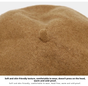 Detail of wool fabric texture on a vintage brown beret showing soft warm material