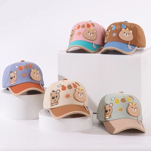 Close-up of baby baseball caps with 3D cartoon bear patches and baby embroidery details