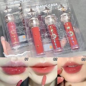Detail view of mirror lip glaze set packaging and three shades swatches on lips