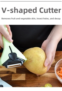 Detail of V-shaped stainless steel eye remover tool on green 3-in-1 vegetable peeler