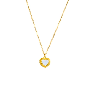 Macro detail of heart pendant with iridescent shell inlay and golden lace border