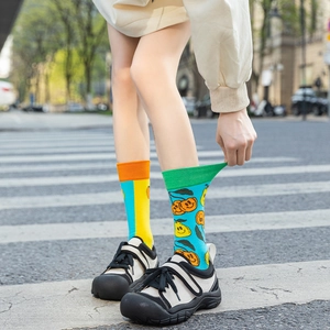 Detail shot of asymmetric cotton socks with fruit patterns and high elastic ribbing